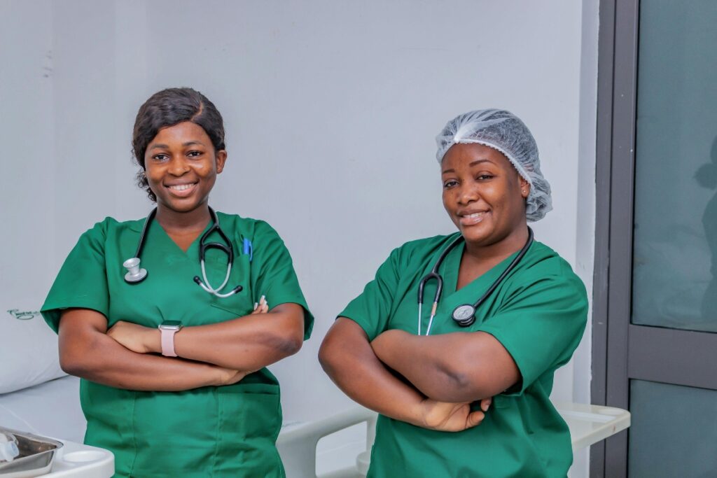 Two nurses in green scrubs.