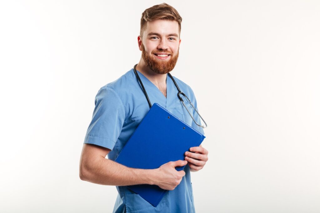 A nurse with files in his hands and a stethoscope around his neck.