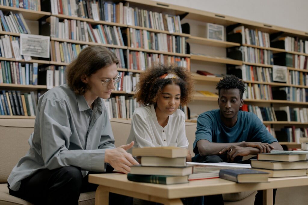 A group of young people in a library trying out different study tips for nursing students.