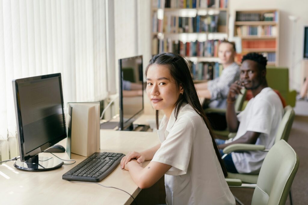 Students sitting at computers at a university library.