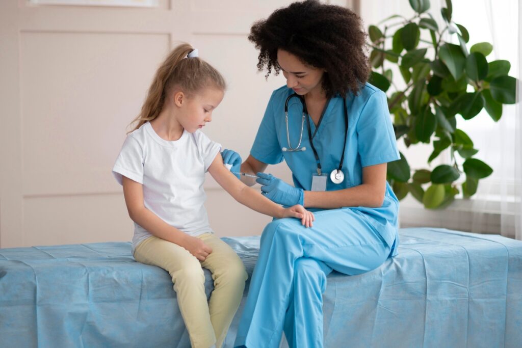 A geriatric care nurse talking to an elderly woman in a nursing home.